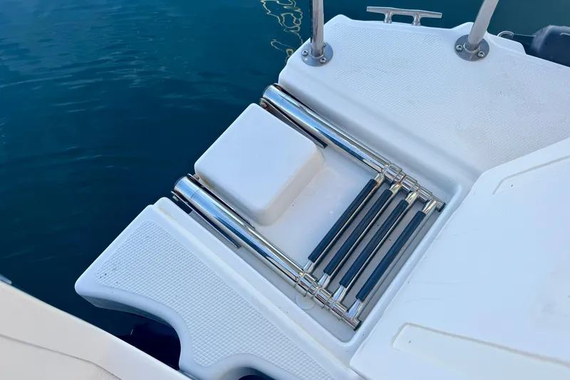 Slide: The Image of Ranger 27 boat swim platform with retractable ladder, 2012 model, on calm water. - 68