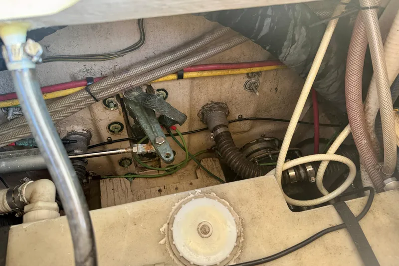 Slide: The Image of Engine compartment of a 2012 Ranger 27 boat, showing hoses and mechanical components. - 73