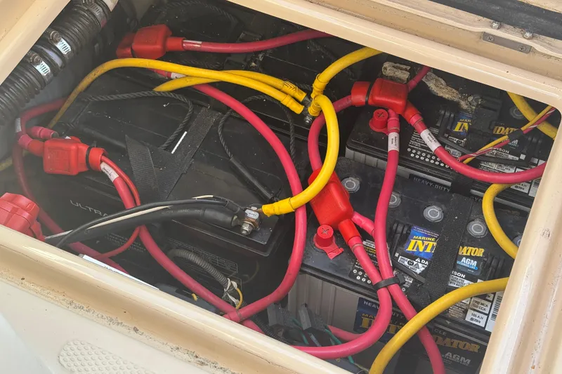 Slide: The Image of Battery compartment of a 2012 Ranger 27 boat with red and yellow cables. - 77