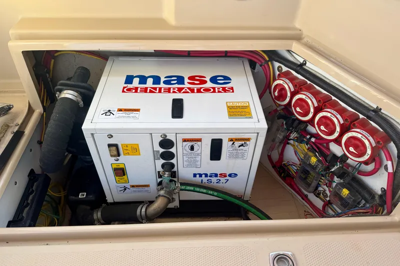 Slide: The Image of Mase generator in a 2012 Ranger 27 boat engine compartment with wiring and controls. - 78