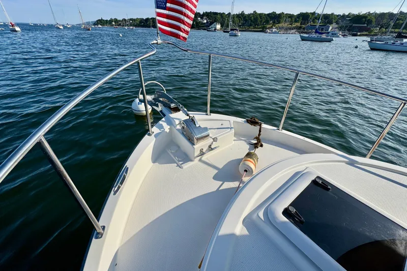 Slide: The Image of Bow of 2012 Ranger 27 boat with American flag, anchored in scenic harbor. - 8