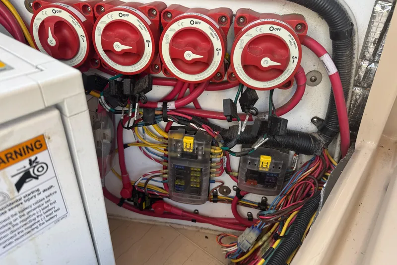 Slide: The Image of Electrical panel with switches and wiring in a 2012 Ranger 27 boat. - 80