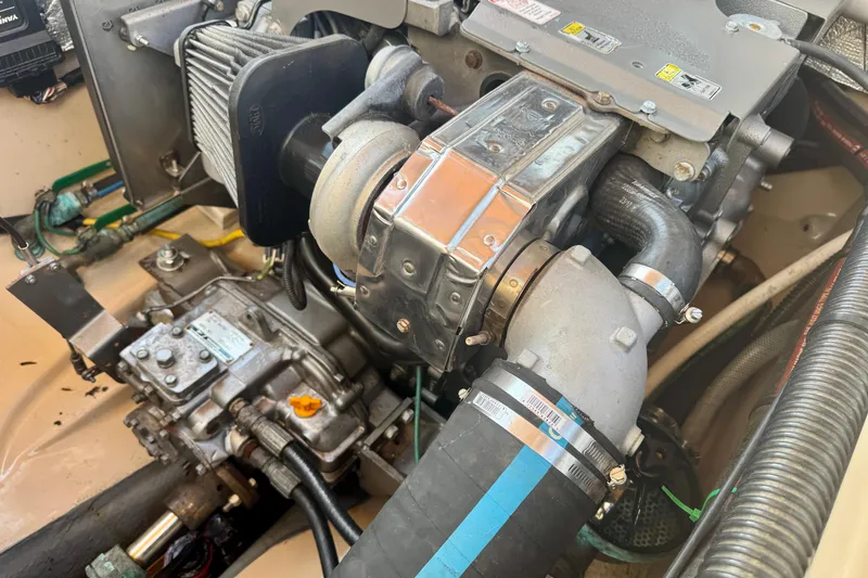 Slide: The Image of Engine compartment of a 2012 Ranger 27 boat, showcasing mechanical components and hoses. - 83