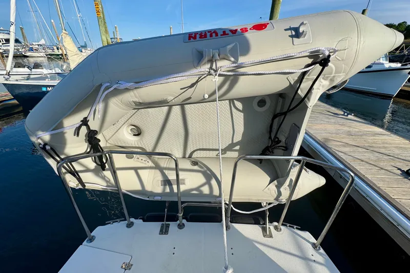 Slide: The Image of Inflatable dinghy secured on a 2012 Ranger 27 boat at a marina dock. - 89