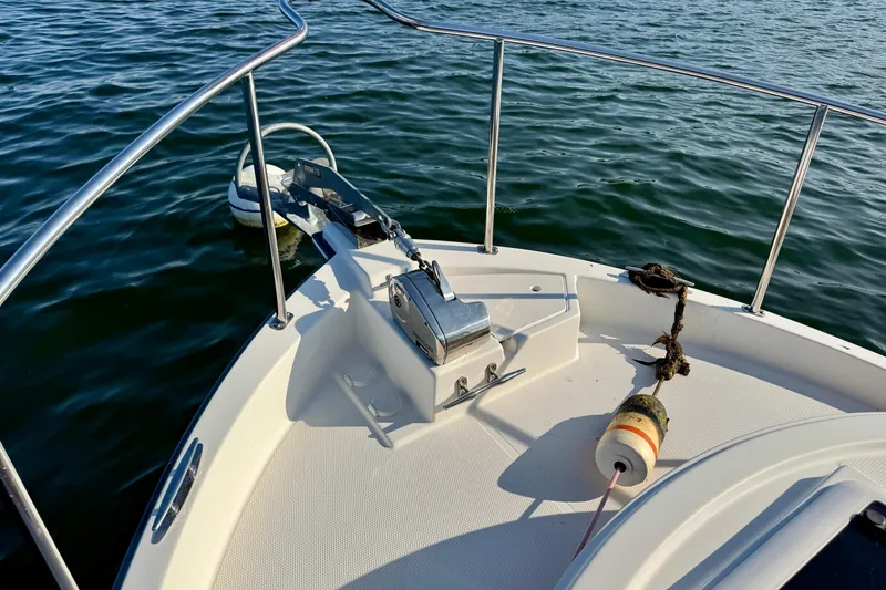 Slide: The Image of Bow of 2012 Ranger 27 boat with anchor and buoy on calm water. - 9