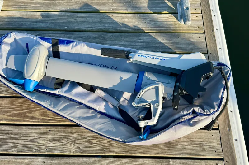 Slide: The Image of Electric outboard motor in carrying case on wooden dock, Ranger 27 model, 2012. - 90