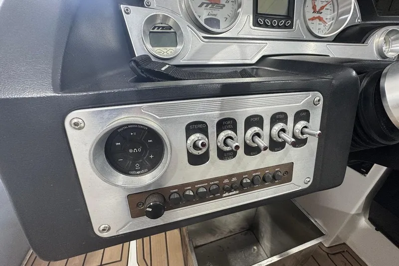 Slide: The Image of Control panel of a 2019 MB F22 Tomcat boat with switches and digital media center. - 12