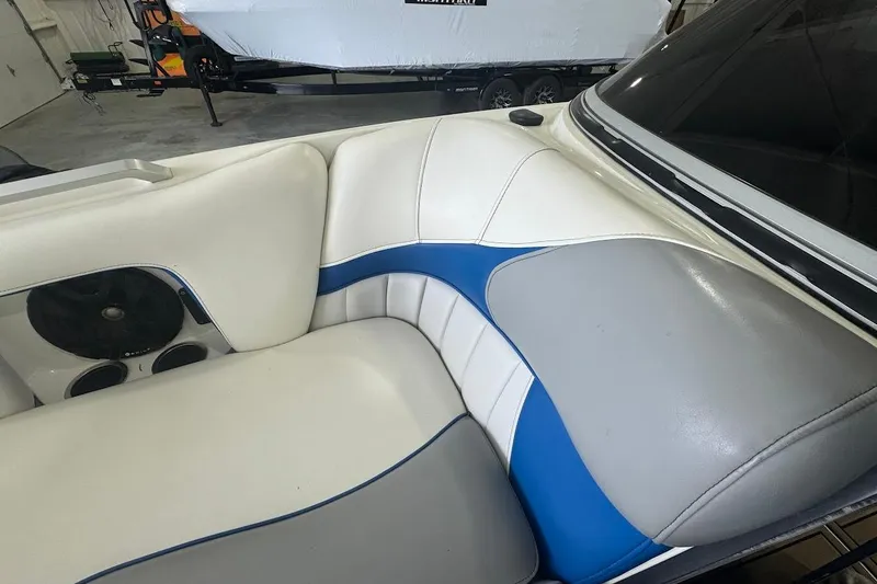 Slide: The Image of Interior of 2019 MB F22 Tomcat boat with white, blue, and gray seating. - 14
