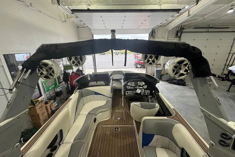Slide: The Image of 2019 MB F22 Tomcat boat interior with speakers and seating in a garage. - 19