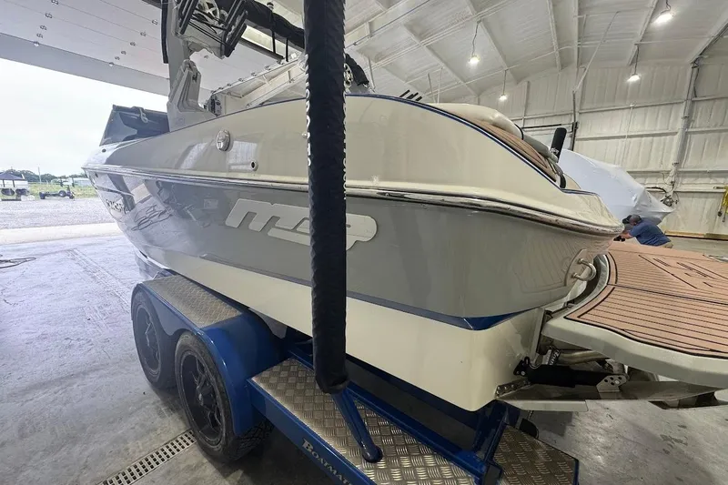 Slide: The Image of 2019 MB F22 Tomcat boat on trailer in a spacious indoor facility. - 3