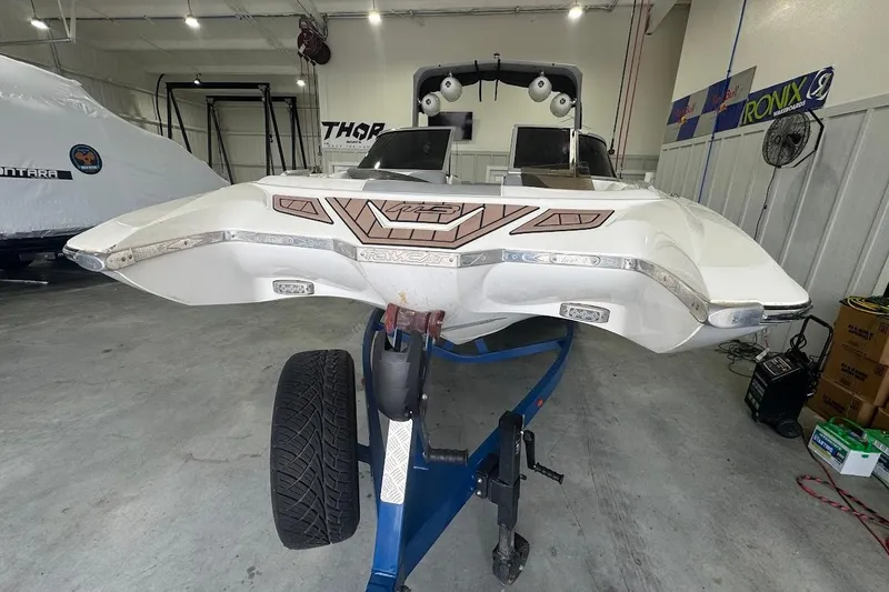 Slide: The Image of 2019 MB F22 Tomcat boat on trailer in garage, showcasing sleek design and modern features. - 5