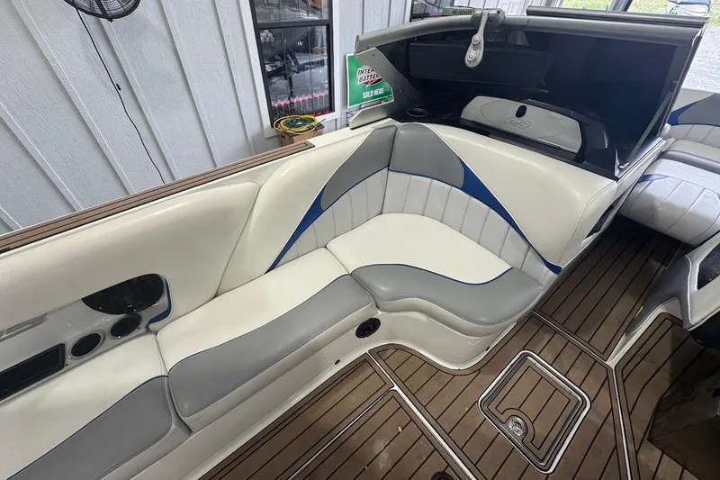 Slide: The Image of 2019 MB F22 Tomcat boat interior with white and gray seating, wood flooring. - 8