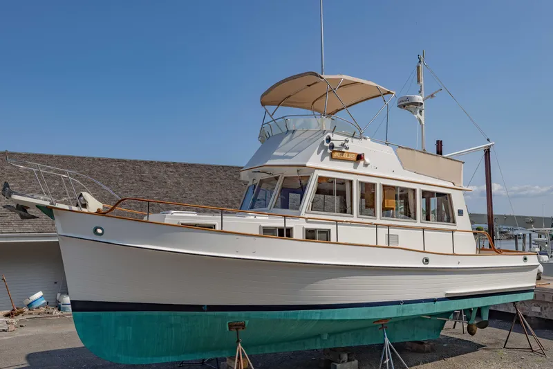 Slide: The Image of 1988 Grand Banks 36 Sedan boat on dry dock, showcasing classic design and structure. - 0