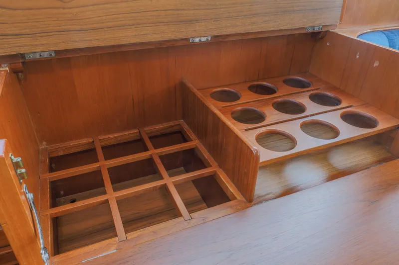 Slide: The Image of Wooden storage compartments on a 1988 Grand Banks 36 Sedan boat interior. - 12
