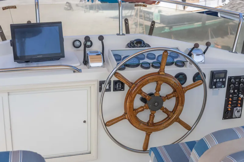 Slide: The Image of 1988 Grand Banks 36 Sedan helm with wooden wheel and navigation equipment. - 18