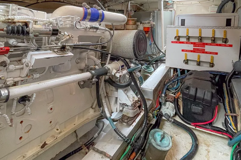 Slide: The Image of Engine room of a 1988 Grand Banks 36 Sedan, showcasing mechanical components and wiring. - 23