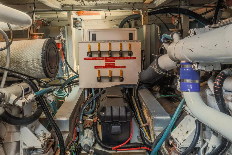 Slide: The Image of Engine room of a 1988 Grand Banks 36 Sedan with visible machinery and control panel. - 24