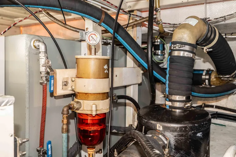 Slide: The Image of Engine room of 1988 Grand Banks 36 Sedan with fuel filter and hoses. - 25