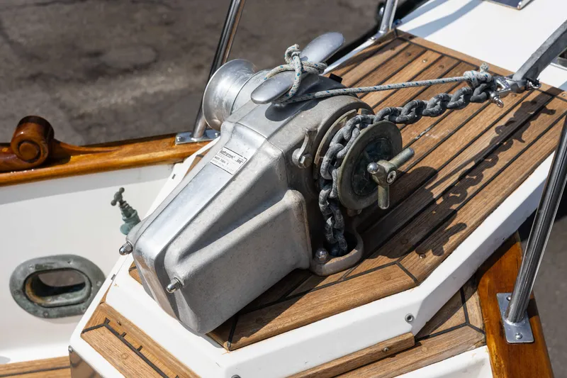 Slide: The Image of Anchor winch on 1988 Grand Banks 36 Sedan boat with wooden deck details. - 27