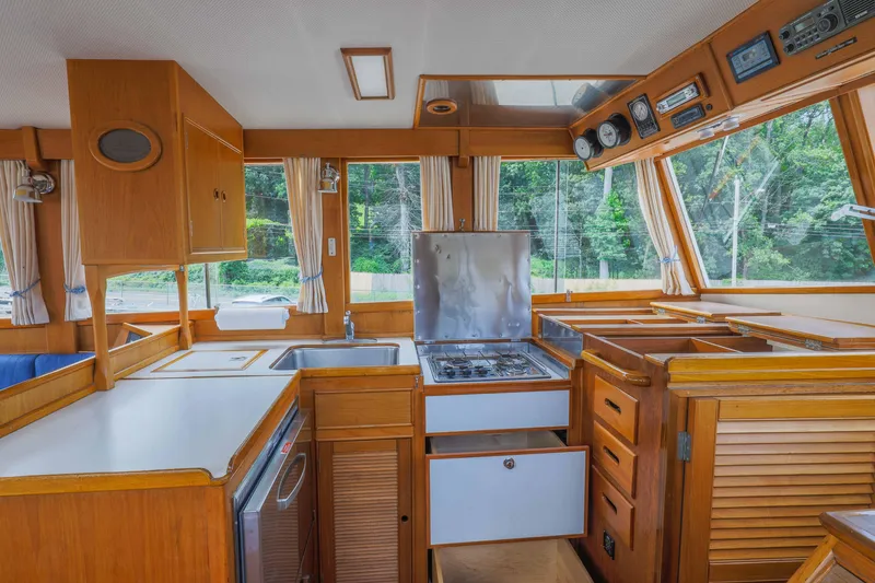 Slide: The Image of Interior of 1988 Grand Banks 36 Sedan yacht kitchen with wood cabinetry and appliances. - 3
