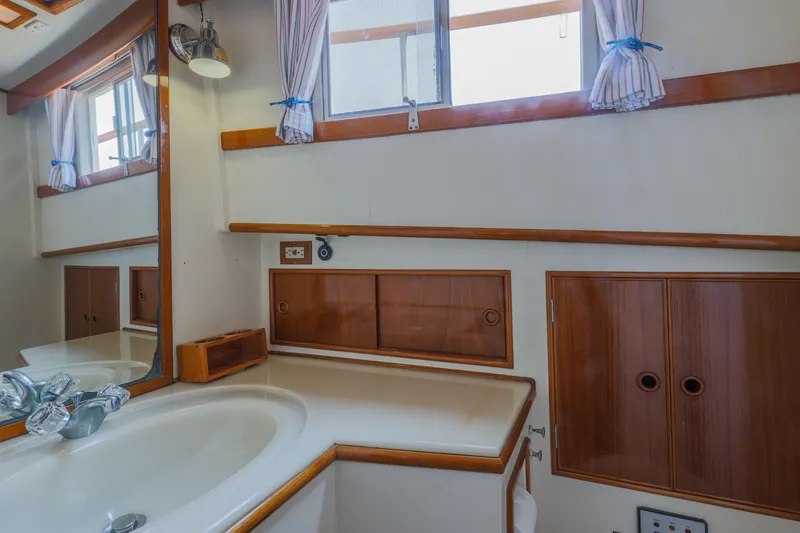 Slide: The Image of 1988 Grand Banks 36 Sedan bathroom with wood accents and a sink. - 7