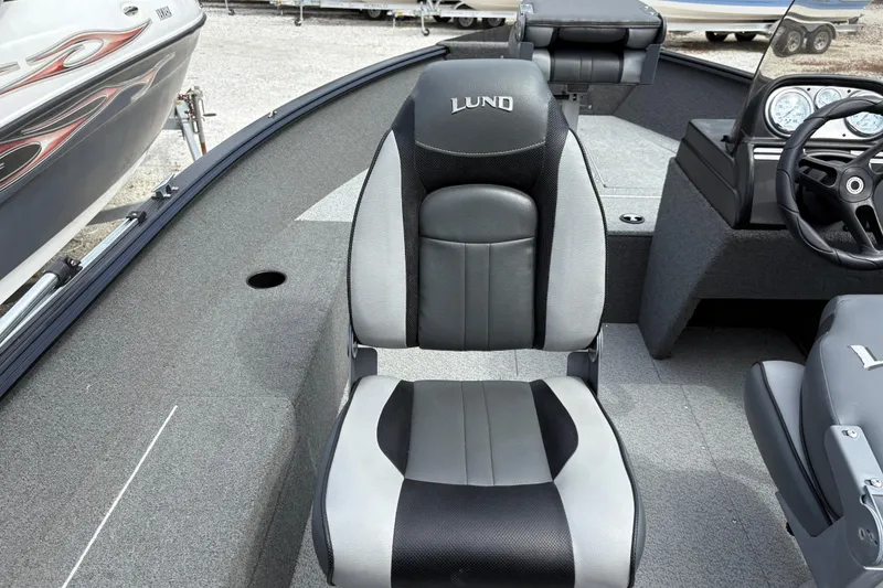 Slide: The Image of 2015 Lund 1650 Rebel XL Sport boat interior with steering wheel and seating. - 10