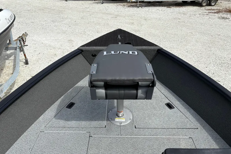 Slide: The Image of 2015 Lund 1650 Rebel XL Sport boat with cushioned seat on deck. - 14