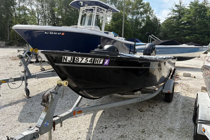 Slide: The Image of 2015 Lund 1650 Rebel XL Sport boat on trailer in outdoor lot. - 2