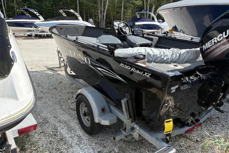 Slide: The Image of 2015 Lund 1650 Rebel XL Sport boat on trailer, featuring Mercury outboard motor. - 3