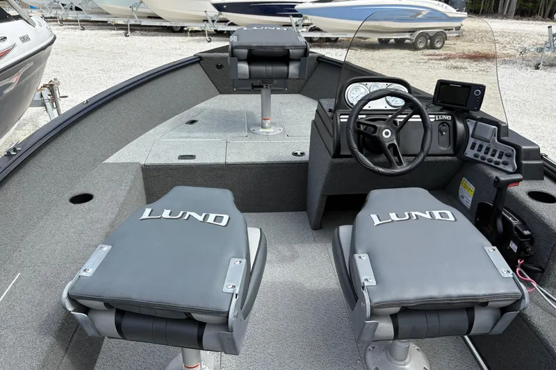 Slide: The Image of 2015 Lund 1650 Rebel XL Sport boat interior with steering console and seating. - 8