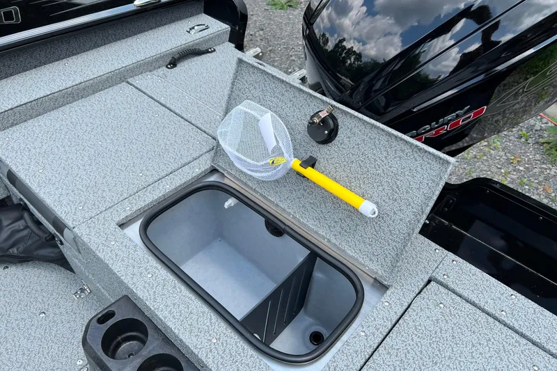 Slide: The Image of 2025 Lund 1775 Adventure Sport boat interior with storage compartment and fishing net. - 13