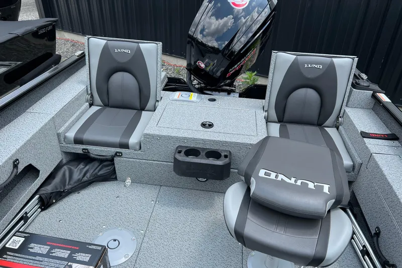 Slide: The Image of 2025 Lund 1775 Adventure Sport boat interior with gray seating and motor. - 17
