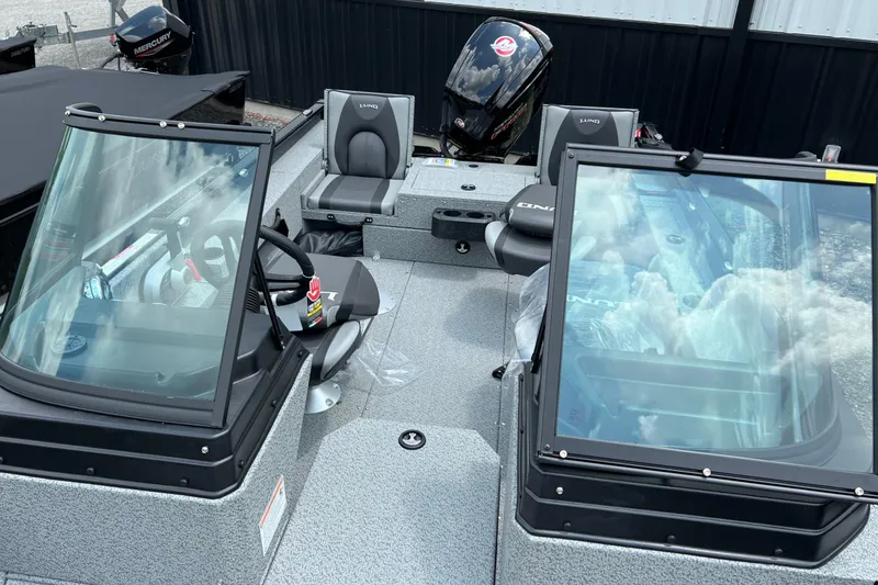 Slide: The Image of 2025 Lund 1775 Adventure Sport boat interior with seating and windshield view. - 18