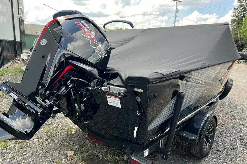 Slide: The Image of 2025 Lund 1775 Adventure Sport boat with Mercury Pro XS engine, covered and parked outdoors. - 4