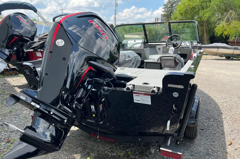 Slide: The Image of 2025 Lund 1775 Adventure Sport boat with Mercury Pro outboard motor, parked outdoors. - 5