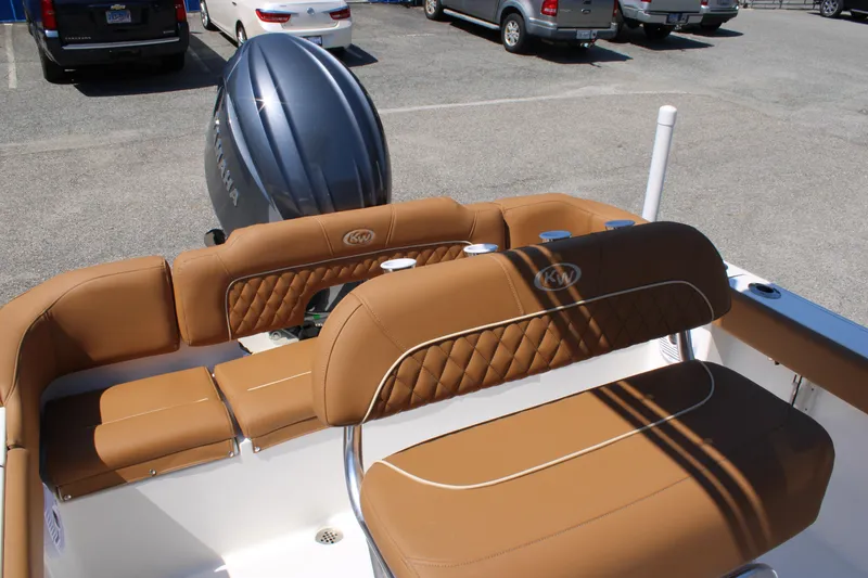 Slide: The Image of 2026 Key West 203 FS boat interior with tan seating and Yamaha engine. - 12
