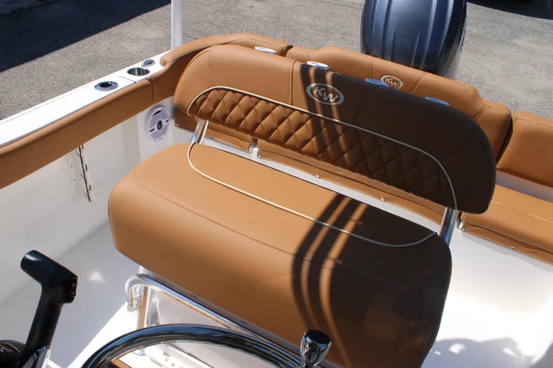 Slide: The Image of 2026 Key West 203 FS boat with tan cushioned seating and steering wheel. - 19
