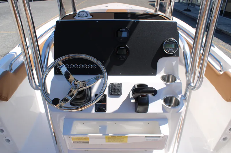 Slide: The Image of 2026 Key West 203 FS boat dashboard with steering wheel, controls, and cup holders. - 20