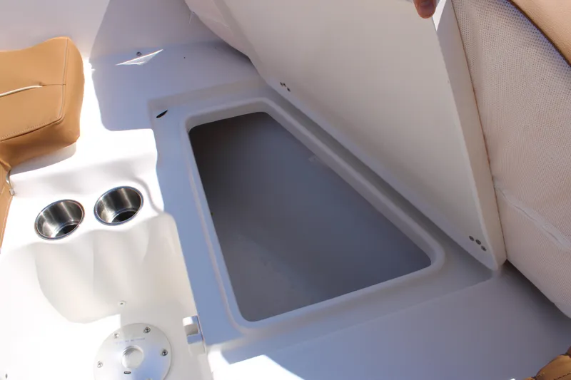 Slide: The Image of 2026 Key West 203 FS boat interior with storage compartment and cup holders. - 22