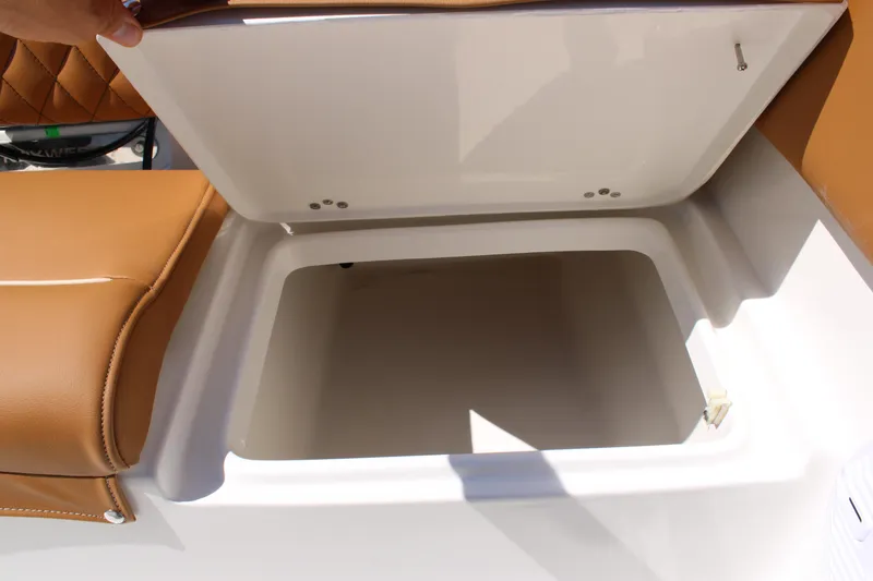 Slide: The Image of Open storage compartment on 2026 Key West 203 FS boat with brown cushioned seating. - 24