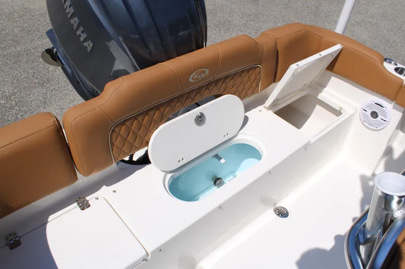 Slide: The Image of 2026 Key West 203 FS boat interior with tan seating and Yamaha engine. - 25