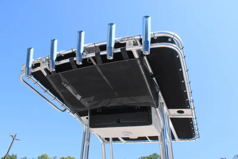 Slide: The Image of T-top of 2026 Key West 203 FS boat with rod holders against blue sky. - 27