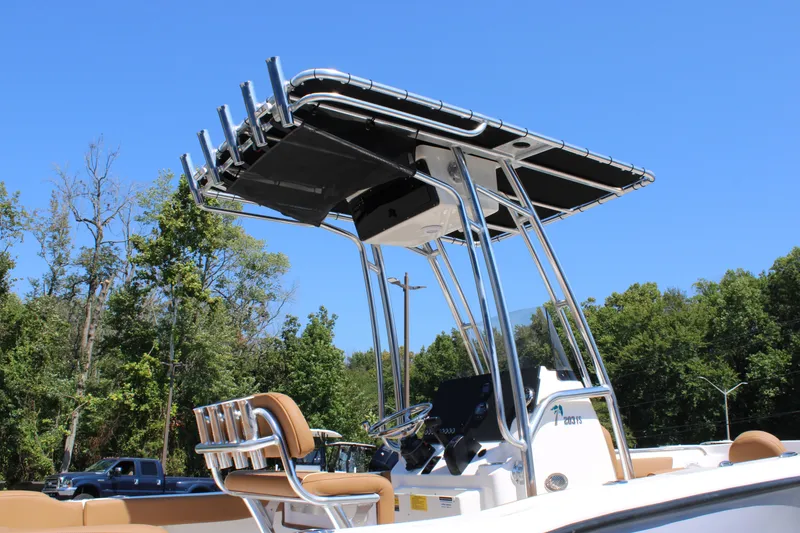 Slide: The Image of 2026 Key West 203 FS boat with T-top and seating, set against a clear blue sky. - 28