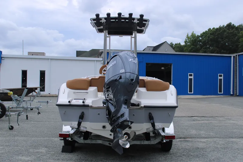 Slide: The Image of 2026 Key West 203 FS boat on trailer, parked outside blue building. - 4