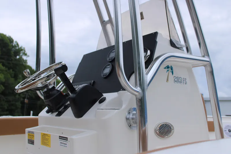 Slide: The Image of 2026 Key West 203 FS boat with tan seating, docked near blue building. - 7