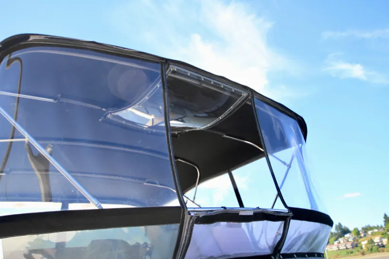 Slide: The Image of 1987 Ocean Alexander 42 boat with clear canopy under blue sky. - 12