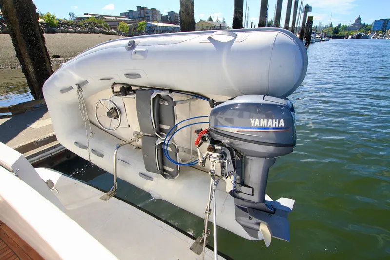 Slide: The Image of Inflatable boat with Yamaha motor on Ocean Alexander 42, 1987 model, docked by the water. - 14