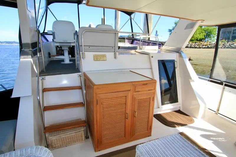 Slide: The Image of 1987 Ocean Alexander 42 yacht interior with wooden cabinetry and seating area. - 20