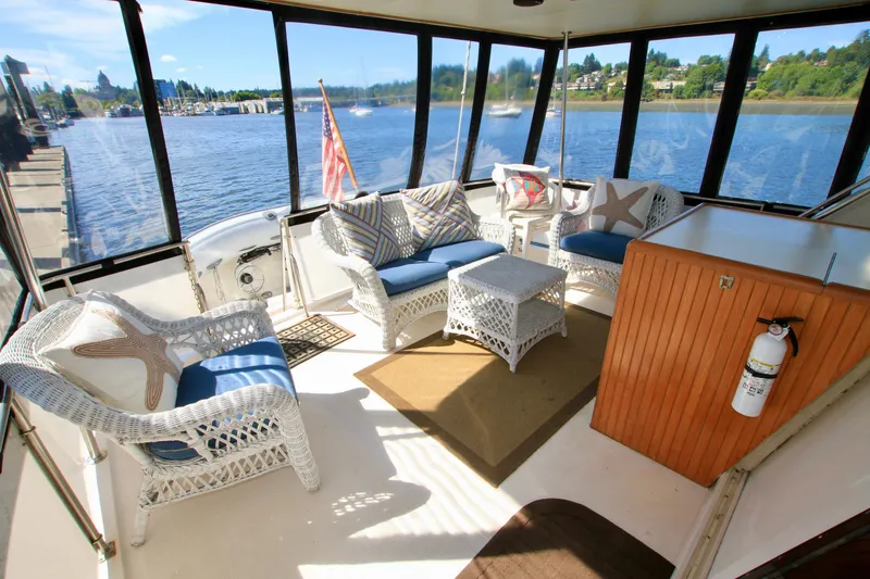 Slide: The Image of 1987 Ocean Alexander 42 yacht interior with wicker furniture and scenic water views. - 21