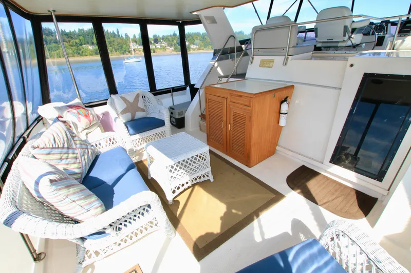 Slide: The Image of Luxurious 1987 Ocean Alexander 42 yacht interior with wicker seating and scenic water view. - 22